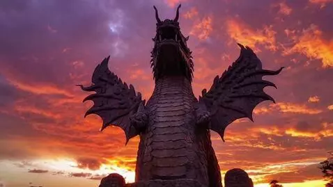 AI Video from prompt: A massive stone dragon statue looms against a fi