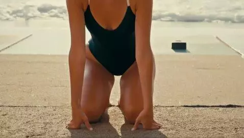 AI Video from prompt: Attracting Woman in swimsuit starts growing and 