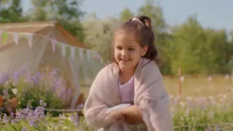 AI Video from prompt: the girl opens her eyes, starts taking off her c