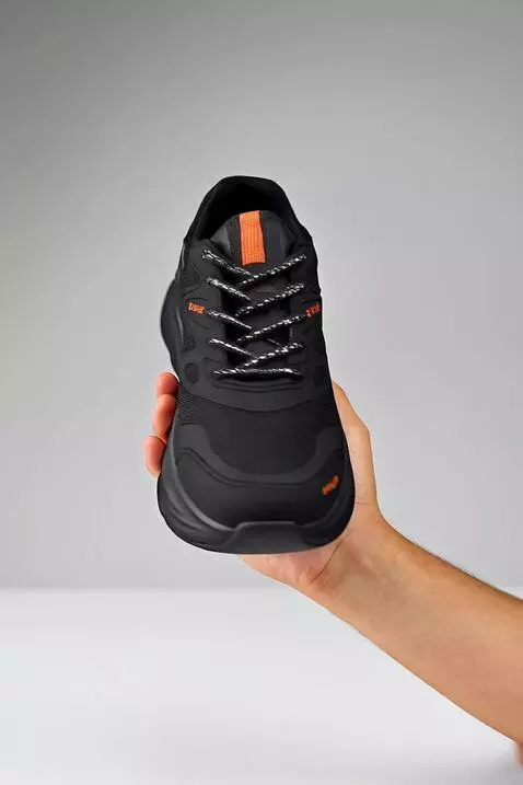 AI Video from prompt: Sepatu sedang di review menggunakan tangan secar