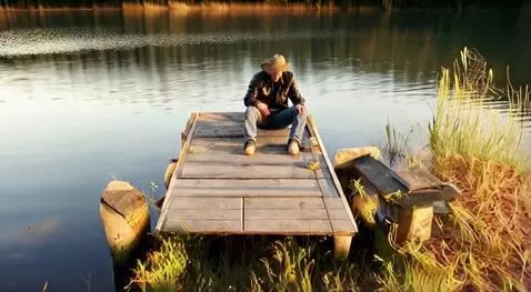 AI Video from prompt: A man sitting on the lake