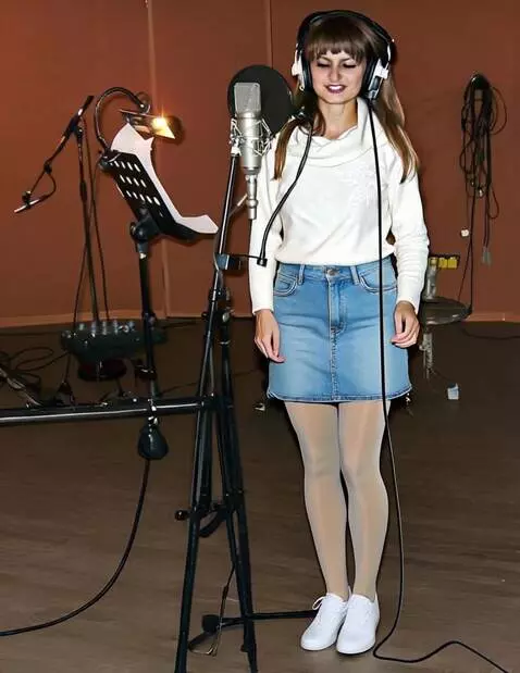 AI Video from prompt: A female vocalist wearing headphones sings in a 