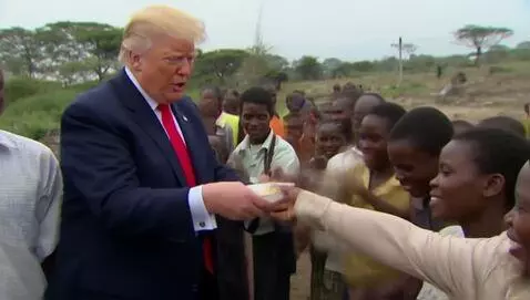 AI Video from prompt: Donald Trump giving refugees food make the backg