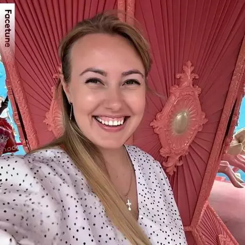 AI Video from prompt: The woman in a polka-dot blouse smiles brightly 