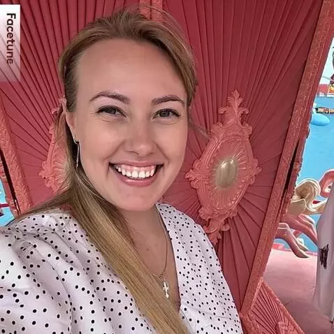 AI Video from prompt: The woman in a polka-dot blouse smiles brightly 