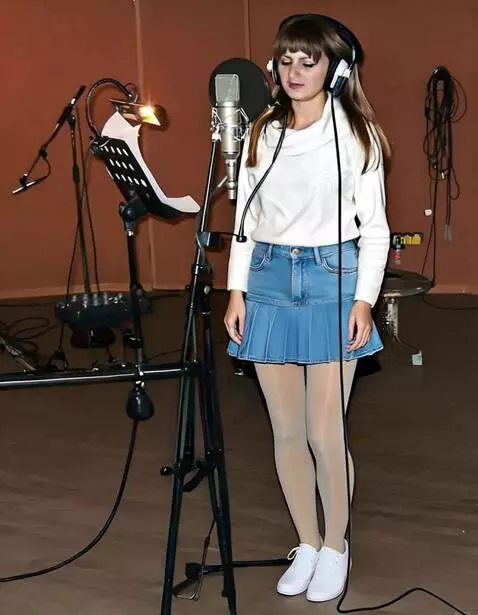 AI Video from prompt: A young woman in a recording studio.  Sings sens