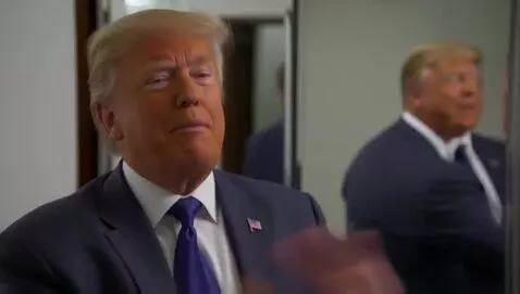 AI Video from prompt: Trump admiring his new breast implants saying th