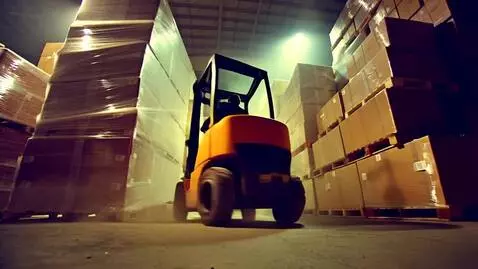 AI Video from prompt: Forklift doing donuts in the warehouse house sta