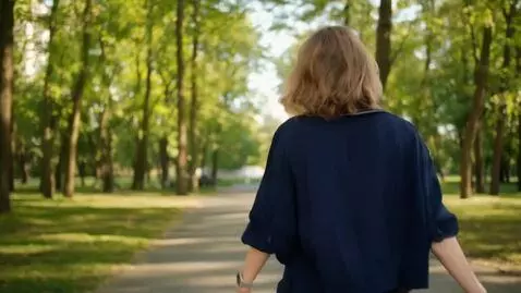 AI Video from prompt: Woman walks through park