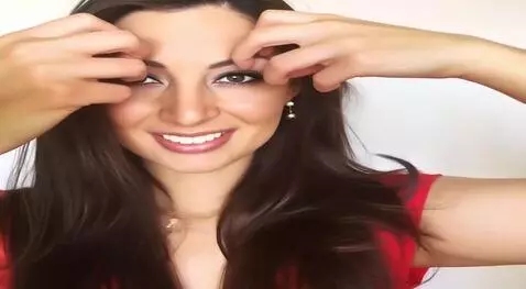 AI Video from prompt: Smiling and running hand through her hair.