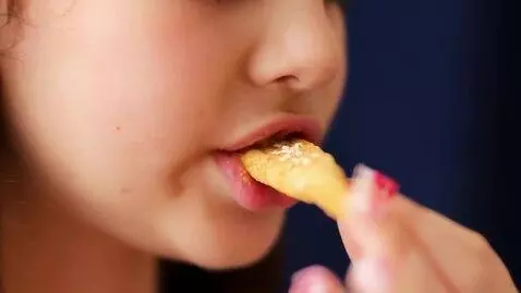 AI Video from prompt: Slow-motion close-up as the Russian girl bites i