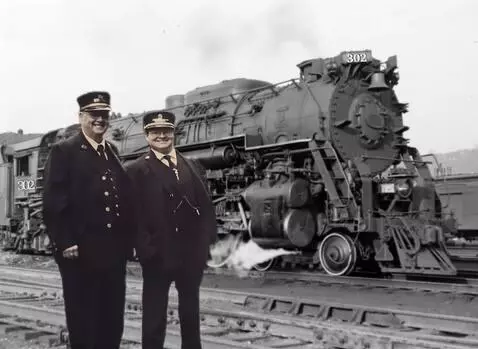 AI Video from prompt: Two Railroad conductor stands and smile waving t