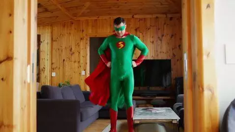 AI Video from prompt: fast zoom on man in superhero costume, green cos