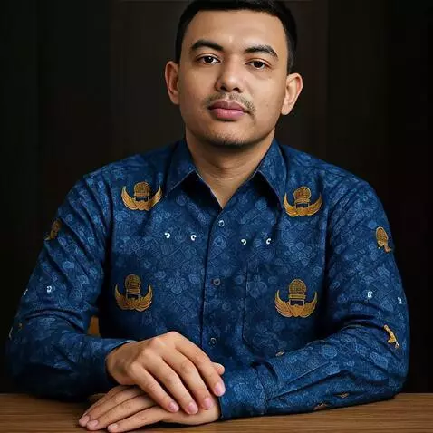 AI Video from prompt: A man wearing a blue patterned batik shirt is si