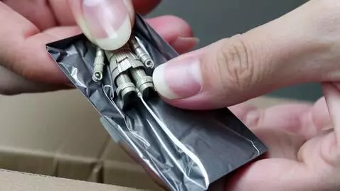 AI Video from prompt: Nure two hand gently pick up the figure on the f