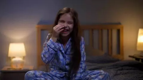 AI Video from prompt: A tiny 18 year old girl laughing and biting her 