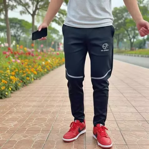 AI Video from prompt: A man in the park showcasing black training pant