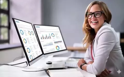 AI Video from prompt: A smiling woman wearing glasses is seated at a d