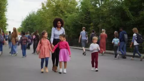 AI Video from prompt: A teacher in  little dress walks down the street