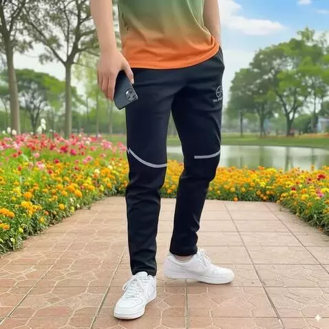 AI Video from prompt: A man in the park showcasing black training pant