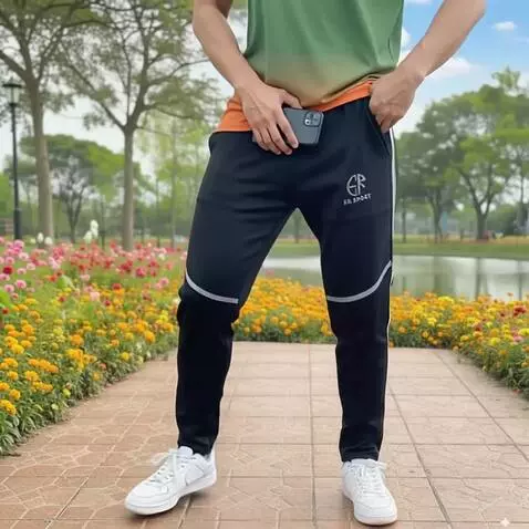 AI Video from prompt: A man in the park showcasing black training pant