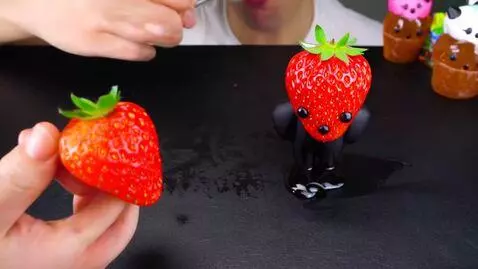 AI Video from prompt: make strawberry with black eyes and small mouth 
