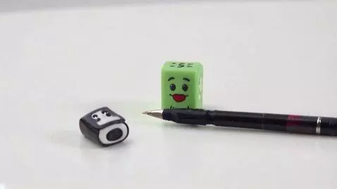 AI Video from prompt: Ластик с рожицей стоит на столе. Вдруг он сломал