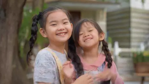 AI Video from prompt: The girl smiles and shrugs her shoulders