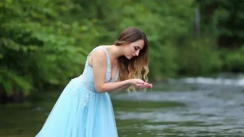 AI Video from prompt: A beautiful woman in a flowing light-blue dress 