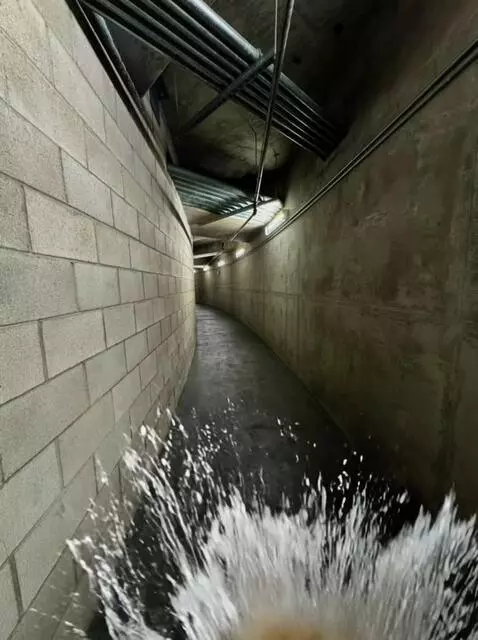 AI Video from prompt: Walking down a hallway water splashing on the fl