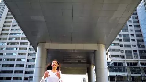 AI Video from prompt: A girl in a white dress runs between gray office