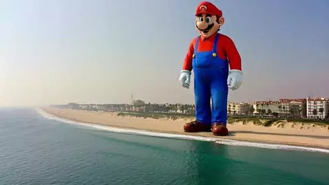 AI Video from prompt: 450ft sized Giant Mario at beach, alive living b