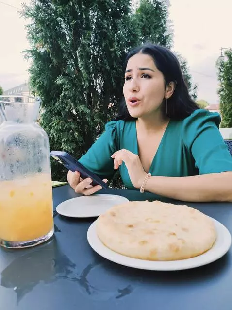 AI Video from prompt: Девушка сидит за столом и поет песню:  Leave the