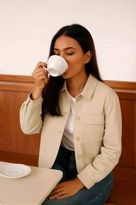 AI Video from prompt: The model elegantly drinks coffee. At the end of