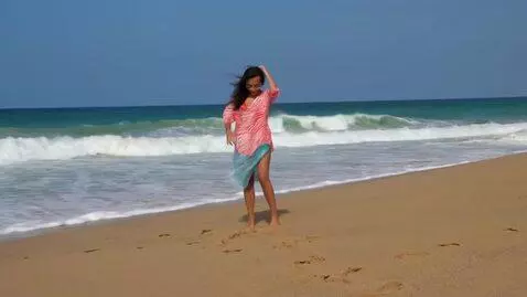 AI Video from prompt: teen girl. Standing on the beach