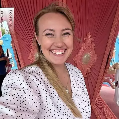 AI Video from prompt: The blonde woman smiles brightly as her white po
