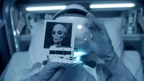 AI Video from prompt: Space Jockey swithout his helmet on is laying in