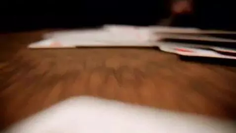 AI Video from prompt: Deck of cards hitting camera lens after being th