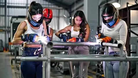 AI Video from prompt: Shot 1: A group of confident female welders in p