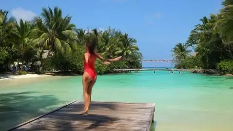 AI Video from prompt: The girl jumping to the clear river from wooden 