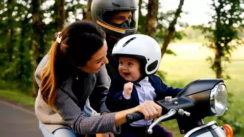 AI Video from prompt: Baby in suit driving scooter and laughing to fin