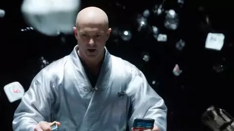 AI Video from prompt: A bald man in a silver robe with an interface ar
