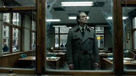 AI Video from prompt: A man in a gray trench coat stands behind the gl
