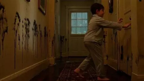 AI Video from prompt: A boy in wet pajamas stands at the end of a hall