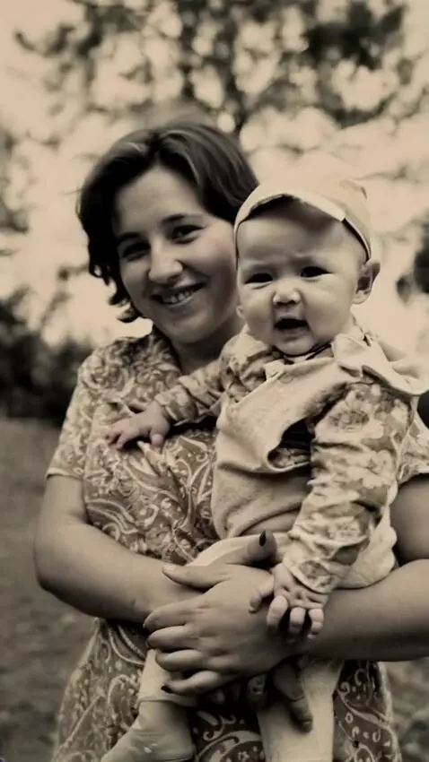 AI Video from prompt: A woman holds a baby in her arms and smiles at t