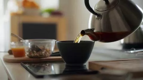 AI Video from prompt: I walk to the kitchen. I turn on the light. I pu