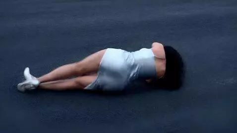 AI Video from prompt: A woman in a silver dress with a thigh-high slit