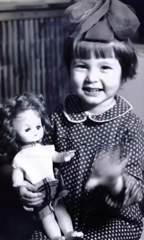 AI Video from prompt: The girl is happy and waves her hand