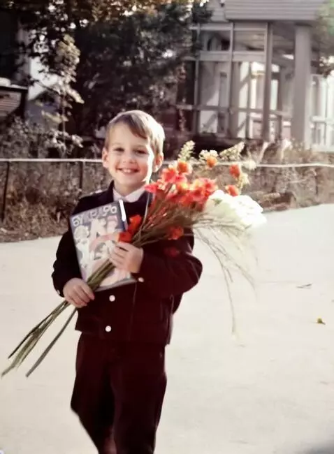 AI Video from prompt: The boy smiles and waves at the camera. He smell