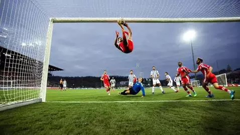 AI Video from prompt: Russuian football team in red T-shirts scoring a